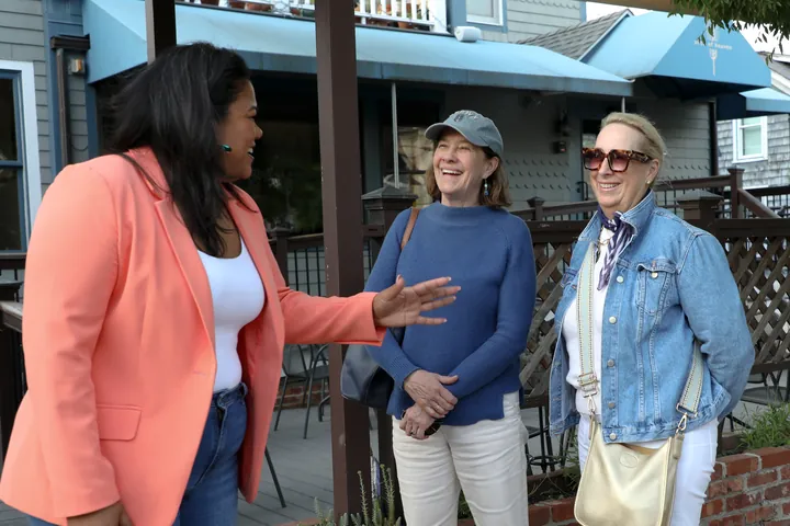 Angela Lima laughing with two supporters in Newport